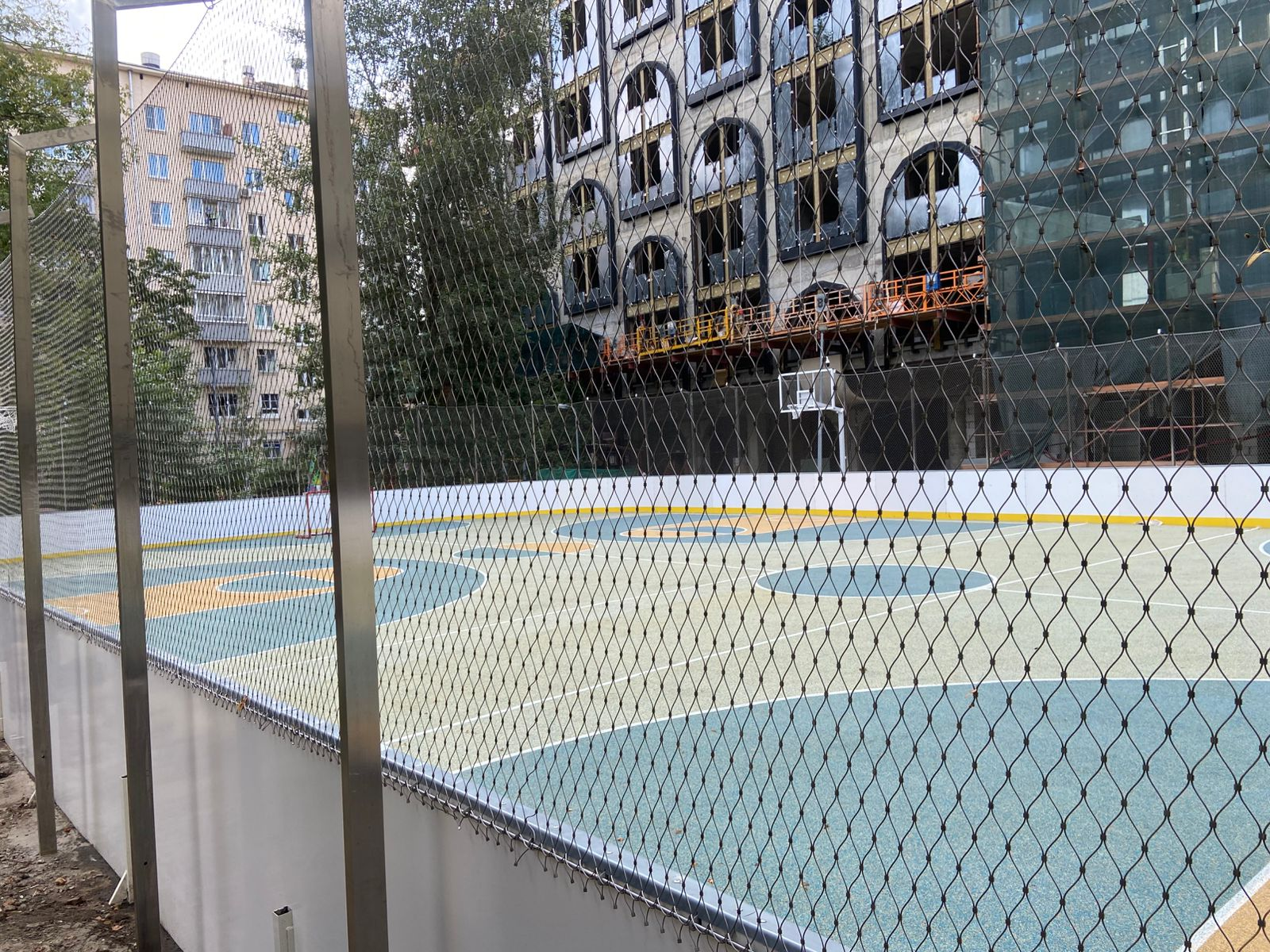 Full overview outdoor multi-sport court stainless steel rope mesh fence surrounding basketball field
