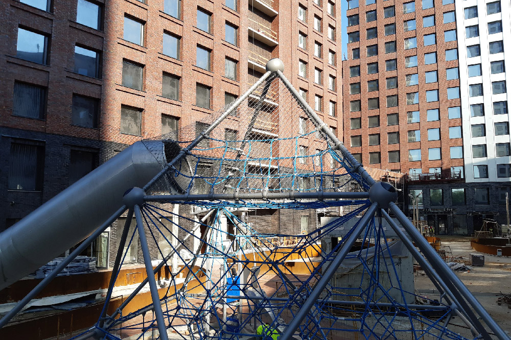 Large Pyramid Stainless Mesh Play Tower Full On-Site Panorama In Downtown Residential District