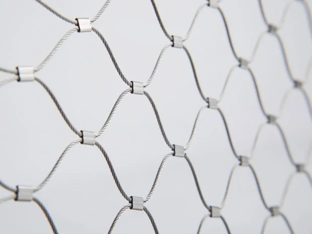 Ferrule crimped stainless steel rope mesh metal sleeve joint close-up