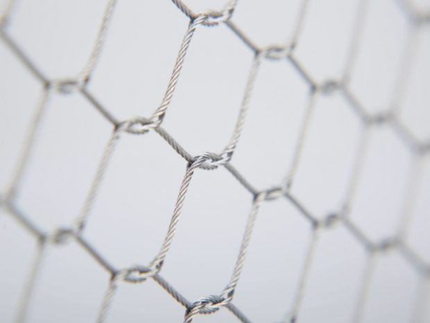 Hand knotted stainless steel rope mesh close-up interwoven knot detail