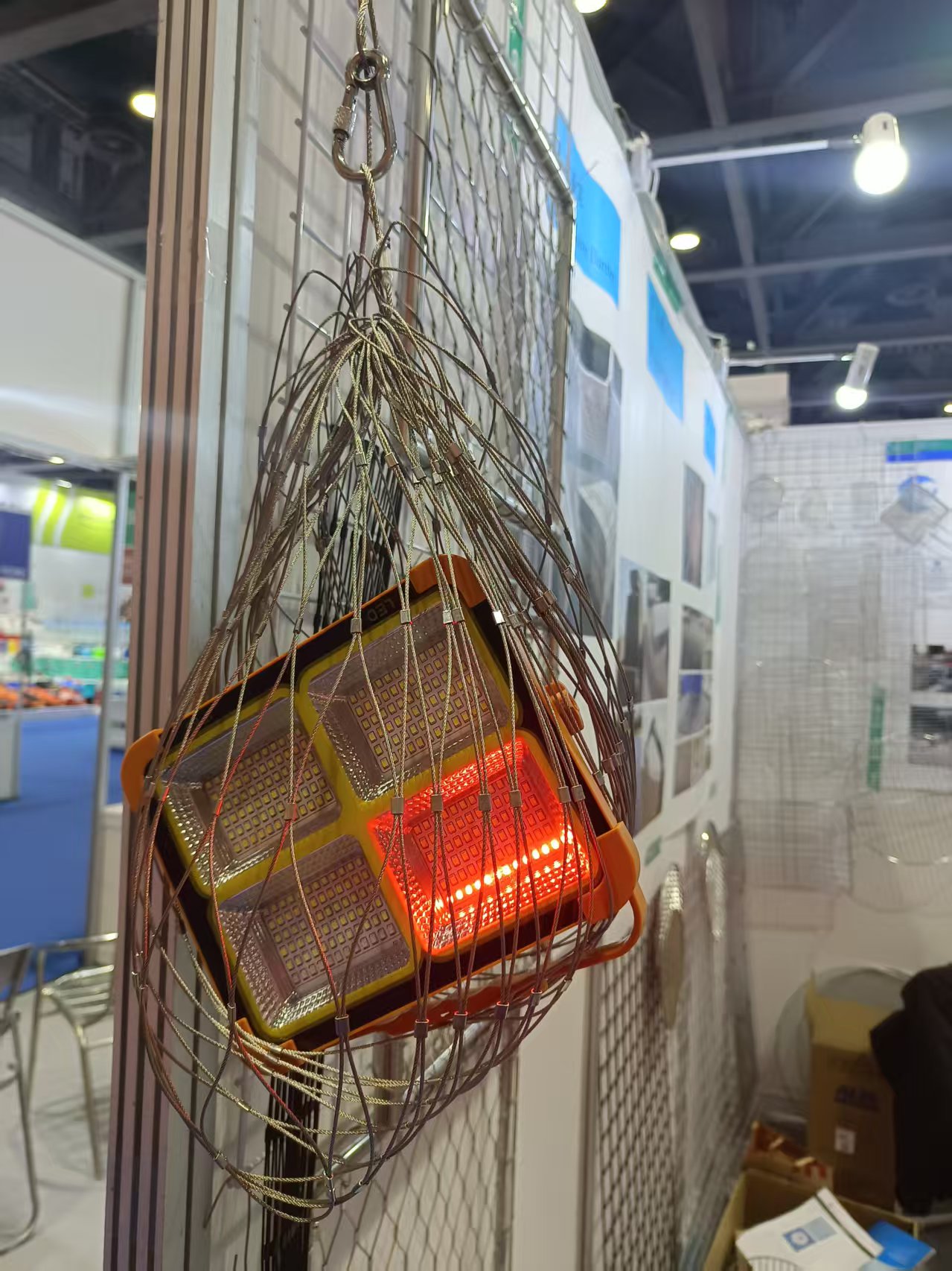 On‑site booth display of finished stainless steel rope mesh products during trade show