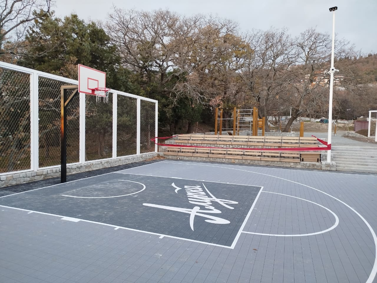 News Article: Hillside Coastal Multi‑Sport Court White Frame Stainless Rope Mesh Enclosure Project