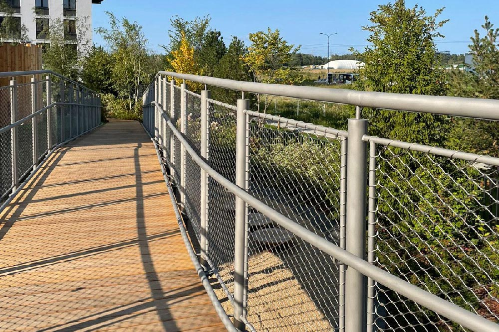 Curved section walkway mesh matching residential building facade